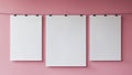 three blank white posters hanging on a pink wall. Royalty Free Stock Photo