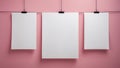 three blank white posters hanging on a pink wall. Royalty Free Stock Photo