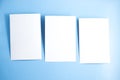 Three blanks white postcards / flyers / invitations mock-up on blue background