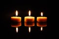 Three blazing wax candles