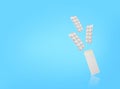 Three blisters of tablets and package are floating on blue backdrop. Copy space. Stock photo Royalty Free Stock Photo