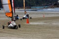 Three blokarts racing around the corner on the sand