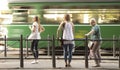 Three blond women standing at a bus stop and waiting for publi Royalty Free Stock Photo