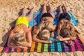 Three blonde girls sunbathing on beach