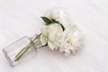 Three blooming peony flowers in glass vase. Vase of flowers fell on table