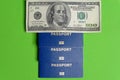 Three blue biometric passports with one hundred dollar denomination