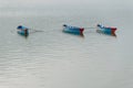 Three blue boats on Phewa Lake in Pokhara