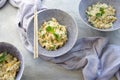 Three blue bowls of rice salad