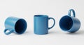 Three Blue Ceramic Mugs in Different Poses on White Background coffee beverage Royalty Free Stock Photo