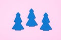 Three Blue Christmas Tree on Light Pink Background Top View Flat Lay Christmas Card or Background Minumal Concept Holiday Concept