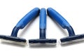 Three blue and green plastic one use disposable shavers white backdrop Royalty Free Stock Photo