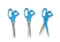 Three blue handled scissors displayed in different open and closed positions Royalty Free Stock Photo