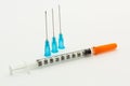 Three blue needles and one 1ml disposable plastic syringe Royalty Free Stock Photo