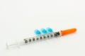 Three blue needles and one 1ml disposable plastic syringe Royalty Free Stock Photo