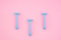 Three blue razors on a pink background. Flatlay Royalty Free Stock Photo