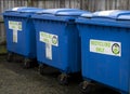 Three blue recycling wheelie bins