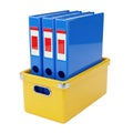 Three blue ring binders in a yellow storage box Royalty Free Stock Photo