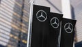 Three black vertical banners with Mercedes logo waving in the wind