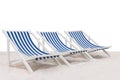 Three blue and white striped beach chair on the sand beach isolated on white background Royalty Free Stock Photo