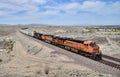 California, Mojave Desert: Three BNSF Locomotives, One CSX Locomotive Pull Long Freight Train Royalty Free Stock Photo