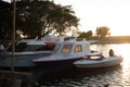 three boats docked in a harbor at sunset Royalty Free Stock Photo