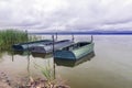 Three boats on the lake cloudy weather Royalty Free Stock Photo