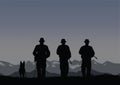 Three border guards with a dog on the border.