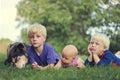 Three Bored Young Children and Dog Relaxing Outside Royalty Free Stock Photo