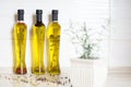 Three bottles of  olive oil with spices on the kitchen table, colorful pepper Royalty Free Stock Photo