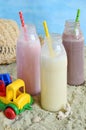 Three bottle of various milkshakes chocolate, strawberry and vanilla . Healthy smoothie with straw. Tasty milk shake cocktails. Royalty Free Stock Photo