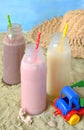 Three bottle of various milkshakes chocolate, strawberry and vanilla . Healthy smoothie with straw. Tasty milk shake cocktails. Re Royalty Free Stock Photo