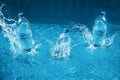 Three bottle of water drop with splash. Shot in motion Royalty Free Stock Photo