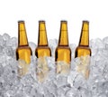 Three bottles of beer on ice cubes Isolated on white background Royalty Free Stock Photo