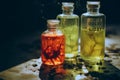 three bottles with different colored liquids sitting on a table Royalty Free Stock Photo