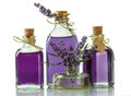 Three bottles with fragrant tincture of lavender and fresh twigs isolated on white background