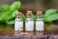 Three bottles of homeopathy globules. Bottles of homeopathic granules. Medicinal herbs on background. Homeopathy medicine Royalty Free Stock Photo