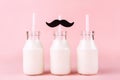 Three bottles of milk of yogurt on pink background Royalty Free Stock Photo