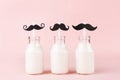 Three bottles of milk of yogurt on pink background Royalty Free Stock Photo