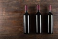 Three bottles of red wine on a wooden background. View from above Royalty Free Stock Photo