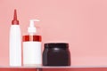 Three bottles of shampoo or shower gel, cream dispenser on colored background with copy space Royalty Free Stock Photo