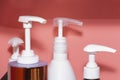 Three bottles of shampoo or shower gel, cream dispenser on colored background with copy space Royalty Free Stock Photo