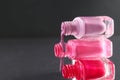 The three bottles of varnish are worth lying on top of each other and nail polish is poured over a black background with a copy of Royalty Free Stock Photo