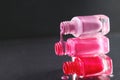 The three bottles of varnish are worth lying on top of each other and nail polish is poured over a black background with a copy of Royalty Free Stock Photo