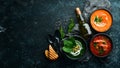 Three bowls with colored soup. Spinach, tomato and carrot soup. Healthy food. Royalty Free Stock Photo