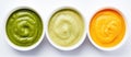 Three bowls of colorful sauces displayed in a row for a dish Royalty Free Stock Photo