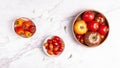 Three bowls with different types and colors of tomatoes and mini bell peppers Royalty Free Stock Photo