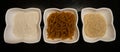 Three bowls of teff products (annual bunch grass, taf, xaafii flour) on a black background