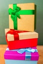 Boxes with bows for Christmas gifts to each other on a green background Royalty Free Stock Photo