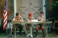 Three Boy Scouts seated at table Royalty Free Stock Photo