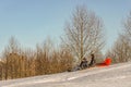 The three boys descend from the mountain on a sled